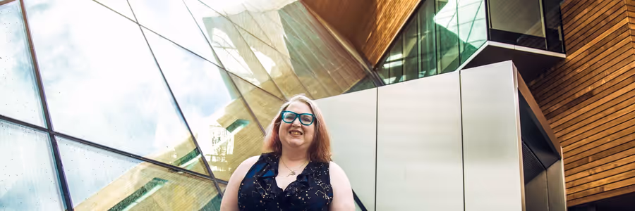 Suzza Silver in front of building on Portland State University Campus