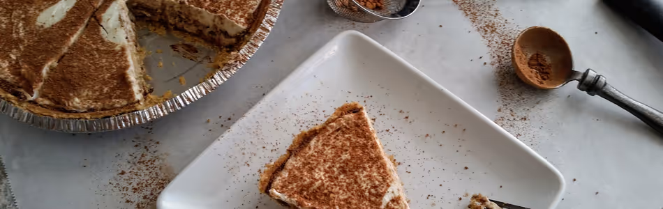 Tiramisu, a coffee flavoried dessert, as a pie decorated with the Pi symbol for Pi day.